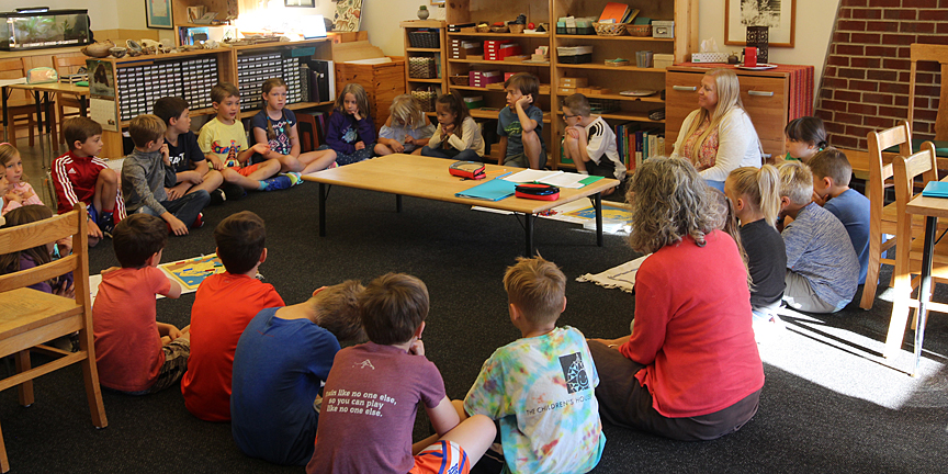 Elementary students participating in a group lesson on grace and courtesy.