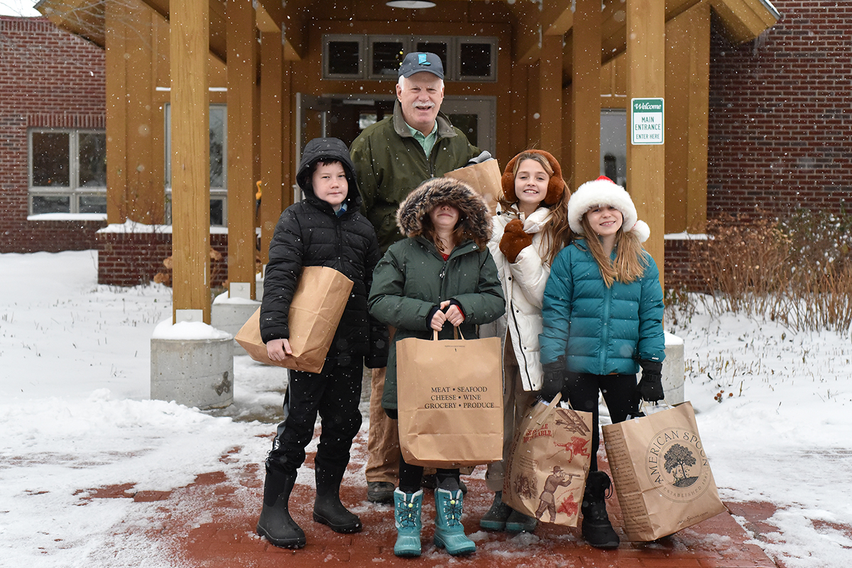 Students help carry socks from our Boots for Kids Sock Drive The Children's House