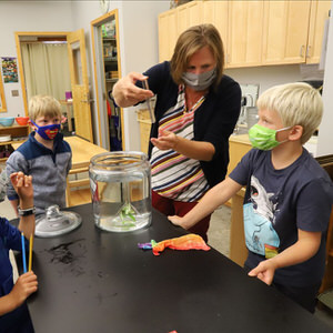 Lower elementary guide and students doing science montessori.jpg