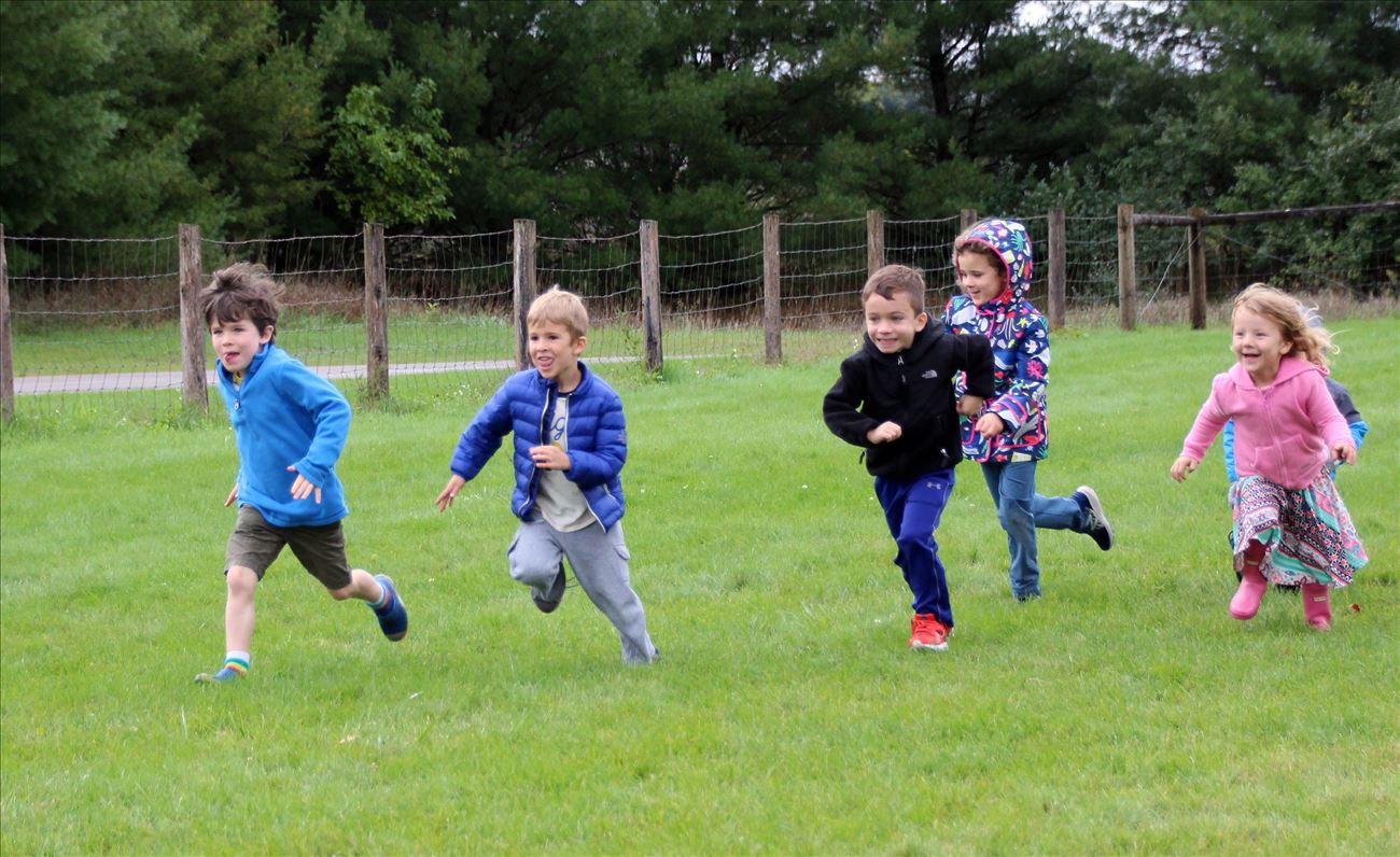 Primary children running on the soccer field
