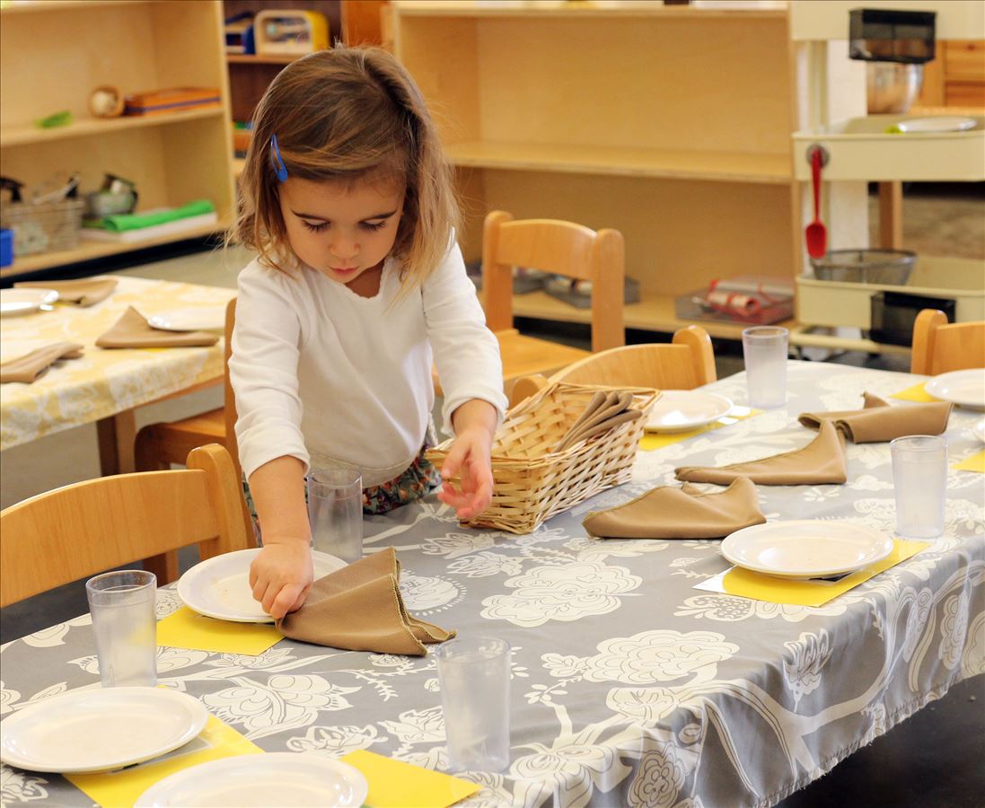 Toddler setting the table